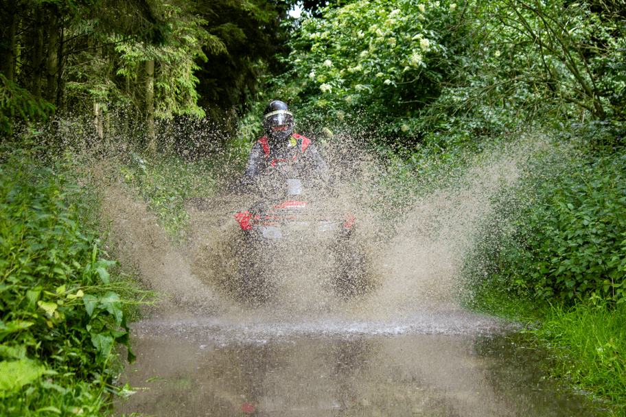 Quad bike splashing through water